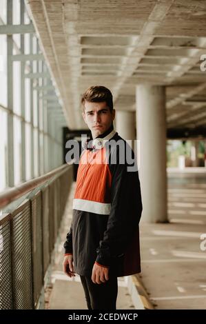 Young thoughtful man standing inside building Stock Photo