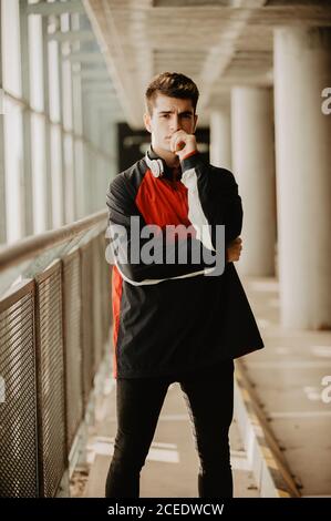Young thoughtful man standing inside building Stock Photo