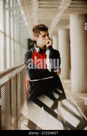 Young thoughtful man standing inside building Stock Photo