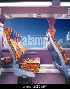 Passenger seats of an old bus, blue sky and clouds in the background, visible through the window. Stock Photo