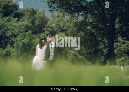Young just married couple walking in grove Stock Photo