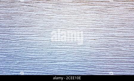 White textured plaster texture. Decorative wall covering with horizontal stripes. Background for text. Light modern abstract background Stock Photo