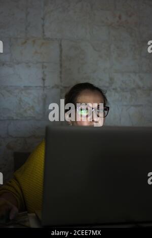 Mature Woman working with her laptop at home Stock Photo