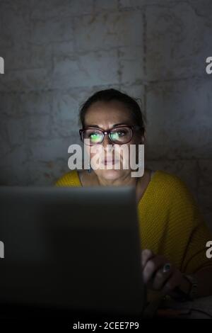 Mature Woman working with her laptop at home Stock Photo