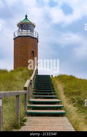 Wooden walkway to a small Lighthouse. Stock Photo