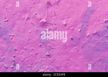 Cracked plaster, peeling pink paint on a concrete wall, scratched stucco texture, decorative design wallpaper, abstract background, natural pattern, g Stock Photo