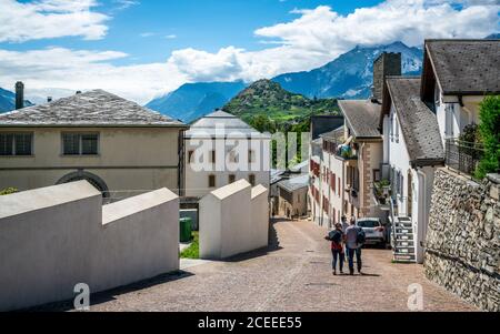 Sion Switzerland , 3 July 2020 : Castles steep street view with people and panorama over the city with hill full of vineyards in Sion old town Valais Stock Photo