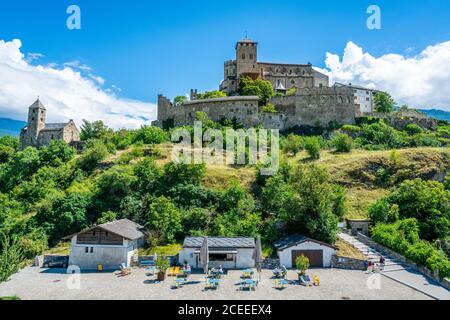 Sion Switzerland , 3 July 2020 : Panorama with small cafe place at bottom of the hill with Valere basilica also called Valere castle in Sion Valais Sw Stock Photo