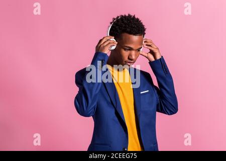Cheerful stylish man in jacket and headphones Stock Photo