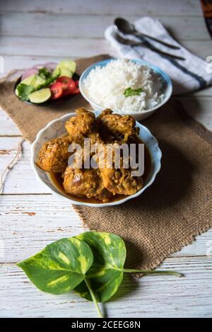 Indian style fried chicken curry with rice, a popular meal.