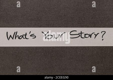White and Grey coloured paper background with Whats Your Story motivational handwritten message Stock Photo