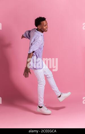 Stylish cheerful young man jumping up Stock Photo