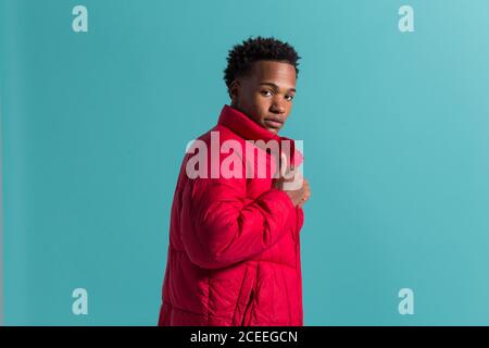 Trendy man in coat and headphones Stock Photo
