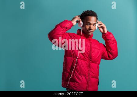 Trendy man in coat and headphones Stock Photo
