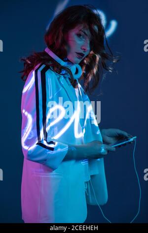 Woman listening to music and using smartphone Stock Photo