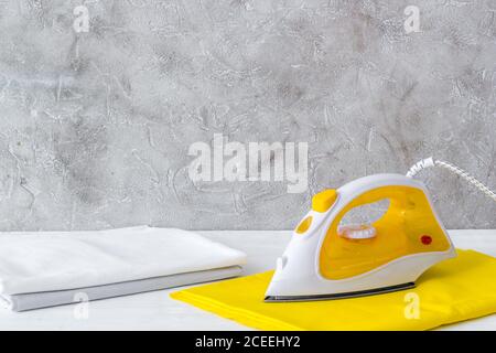 Close up of iron and towels on ironing board Stock Photo