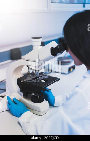 Young Woman using microscope in laboratory Stock Photo