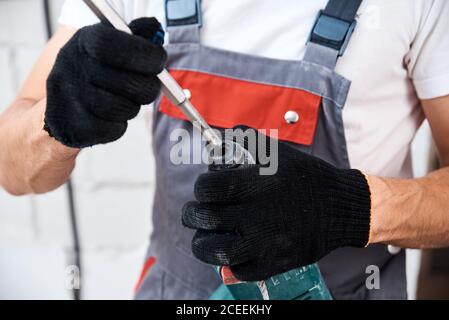 Man worker using hammer drill, close up Stock Photo