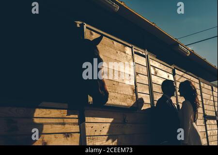 shot of silhouette of couple standing in the garden at the house. Stock Photo