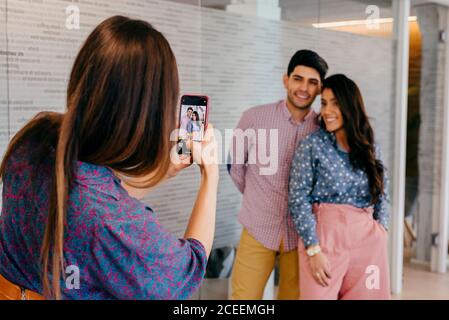 Woman taking shot of people in office Stock Photo