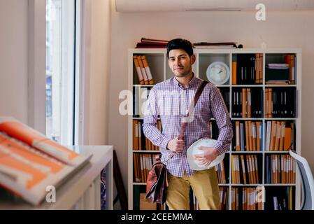 Handsome young man looking at camera in office Stock Photo
