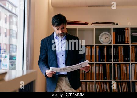Adult man with papers in office Stock Photo