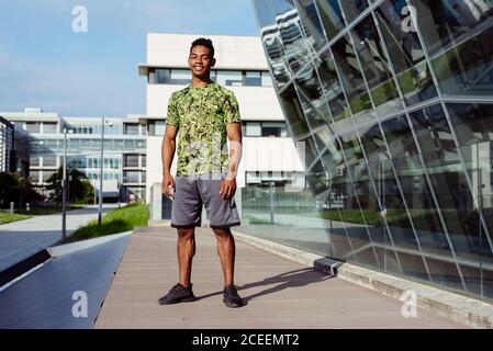 Handsome ethnic man posing in city Stock Photo