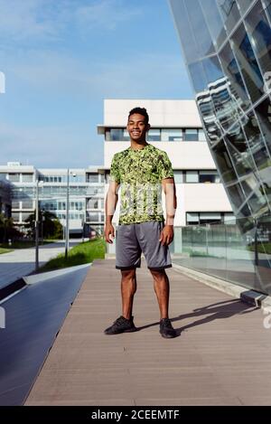 Handsome ethnic man posing in city Stock Photo