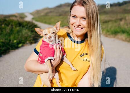 girl with small Chihuahua in sunlight Stock Photo