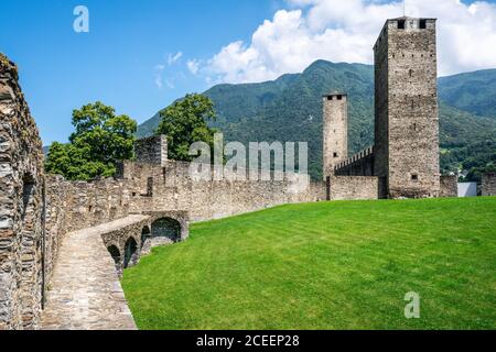 Scenic view of Castelgrande castle with the two black and white towers and wall walk in Bellinzona Ticino Switzerland Stock Photo