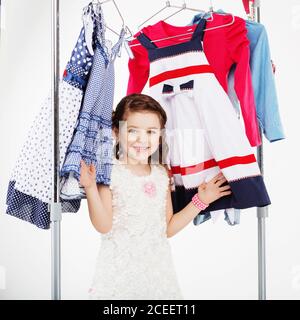 Little woman trying new clothing on white background. Small girl ...
