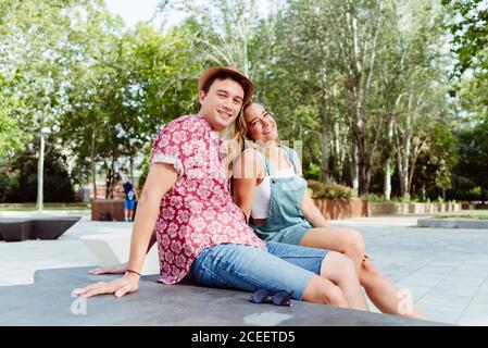 Couple sitting on bench Stock Photo