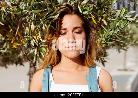 Smiling Woman at tree Stock Photo
