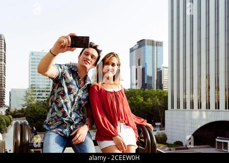Couple taking selfie at handrail Stock Photo