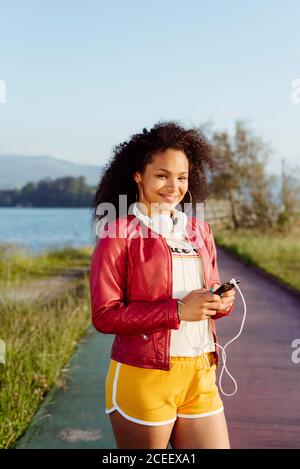 African-American Woman with smartphone in countryside Stock Photo