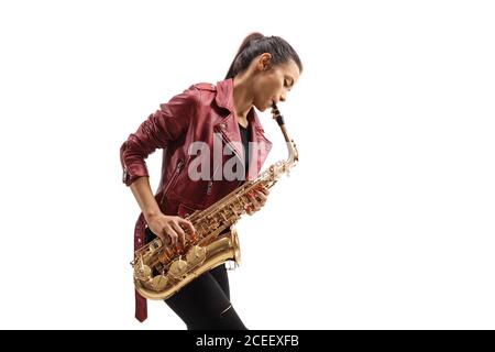 Young female musician in a leather jacket playing a saxophone isolated on white background Stock Photo