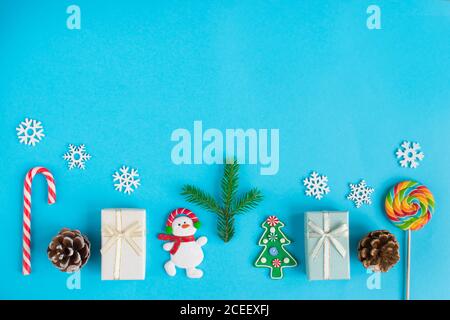 Various Christmas decorations at the bottom on a blue background. Stock Photo