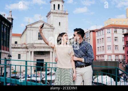 Couple taking selfie on town street Stock Photo