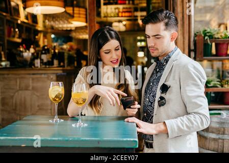 Couple sitting at table in outside cafe Stock Photo