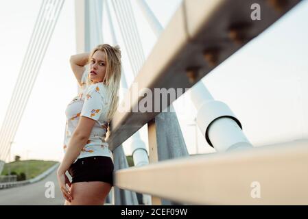 Young Woman standing on bridge Stock Photo