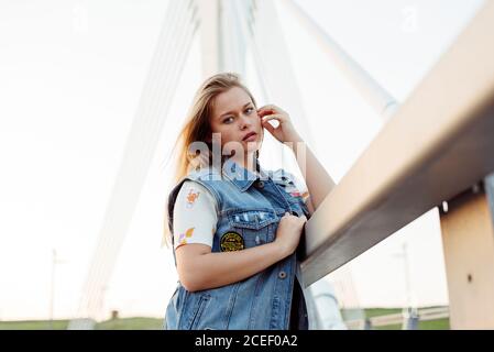 Young Woman standing on bridge Stock Photo
