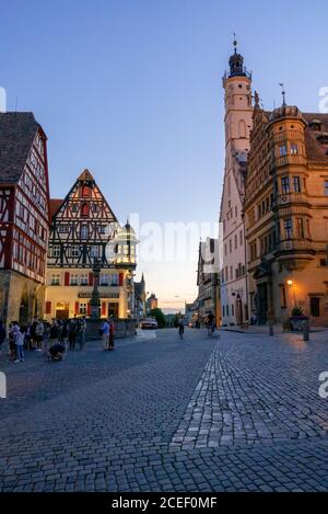 Rothenburg ob der Tauber, Bavaria / Germany - 23 July 2020: people enjoy a beautiful summer evening in the market square of Rothenburg Stock Photo