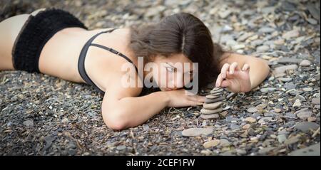Portrait of woman and zen stones in foggy day. Stock Photo