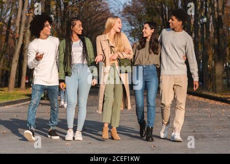 Full size photo of happy teenagers walking in park Stock Photo