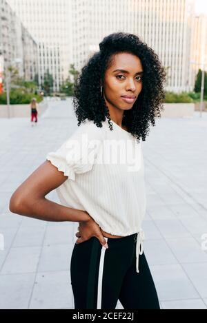 Laughing African-American Woman on street hands up Stock Photo
