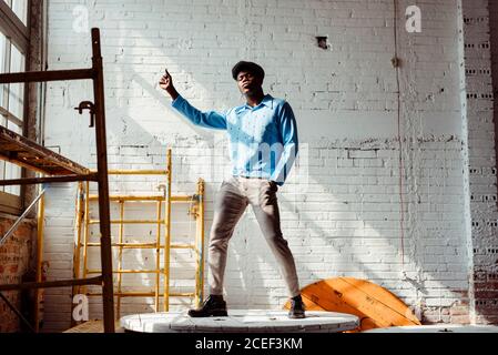 Black man dancing on table Stock Photo