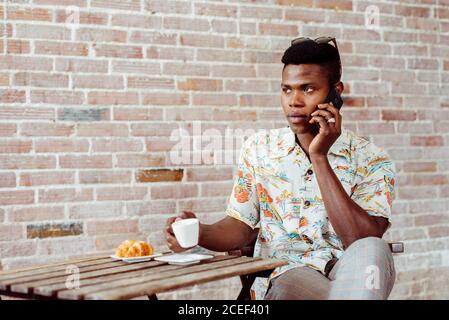 man using smartphone during breakfast Stock Photo