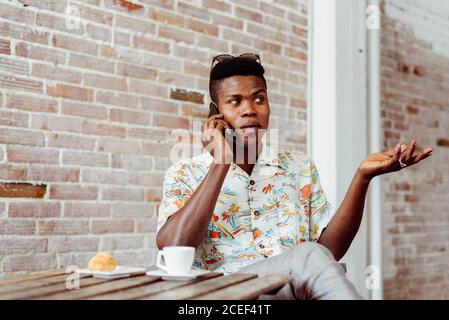 man using smartphone during breakfast Stock Photo