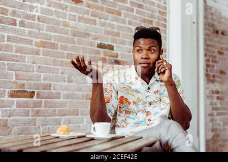 man using smartphone during breakfast Stock Photo
