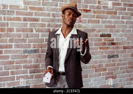 man with playing card throwing dices Stock Photo